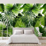 Papel de parede Padrão exuberante de folhas tropicais verdes.