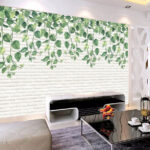 Papel de parede Parede de tijolo branco com folhas verdes